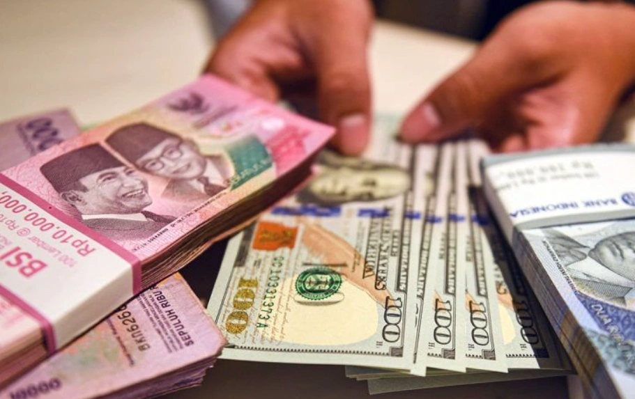 Uang rupiah di dekat tumpukan Dolar AS.(Antara)